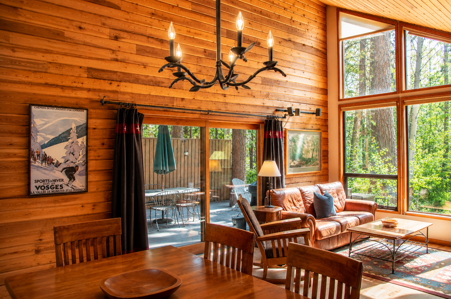 Step into your inviting living space, where rustic wood beams, cozy seating, and expansive forest views create the perfect retreat for relaxing after a day of adventure.