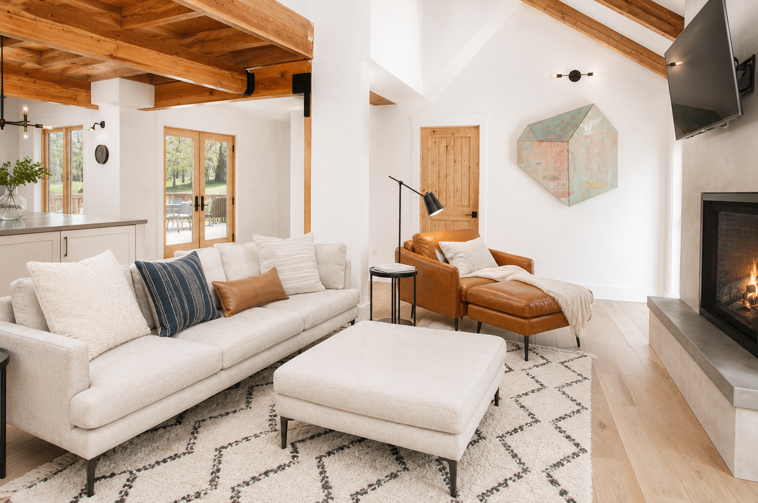 Sink into plush seating in your airy living room, where exposed beams and a cozy fireplace create the perfect spot to unwind after a day of adventure.