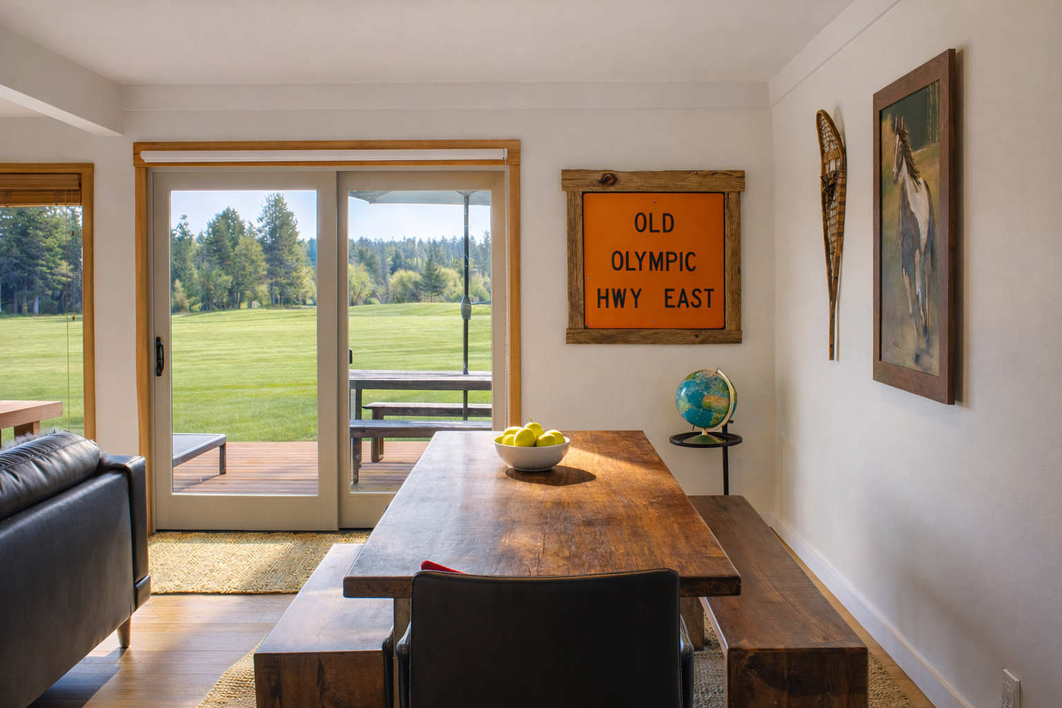 Gather around the rustic wooden table where shared meals become cherished memories, with peaceful fields stretching beyond your private deck.