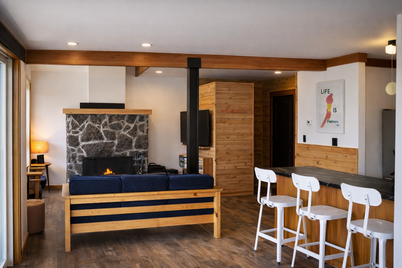 Warm up beside your crackling stone fireplace while you sip morning coffee at the breakfast bar in this cozy, modern retreat.