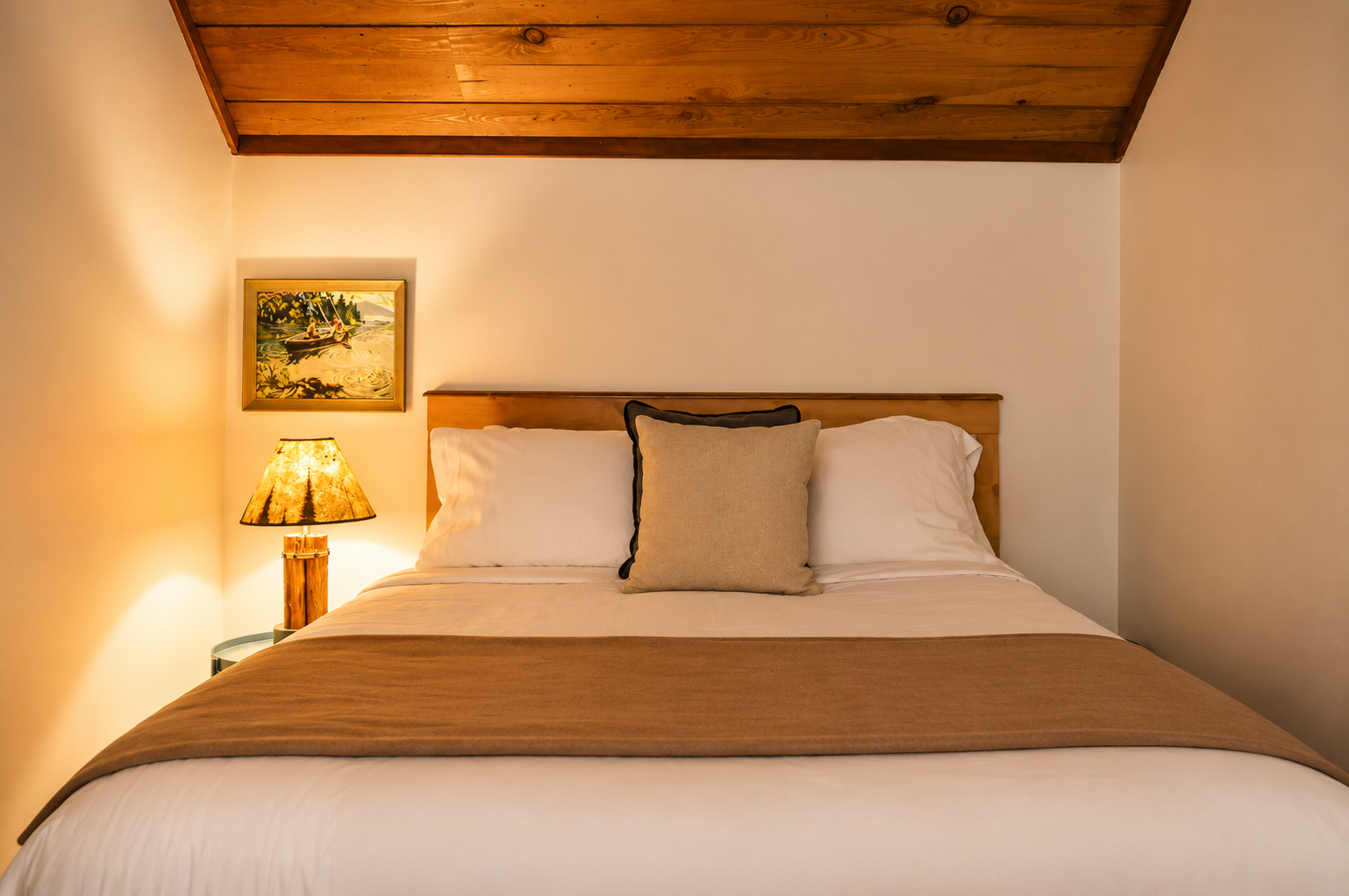 Sink into crisp linens beneath warm wood-beamed ceilings. Soft bedside lighting and thoughtful touches create your cozy mountain retreat for restful nights.
