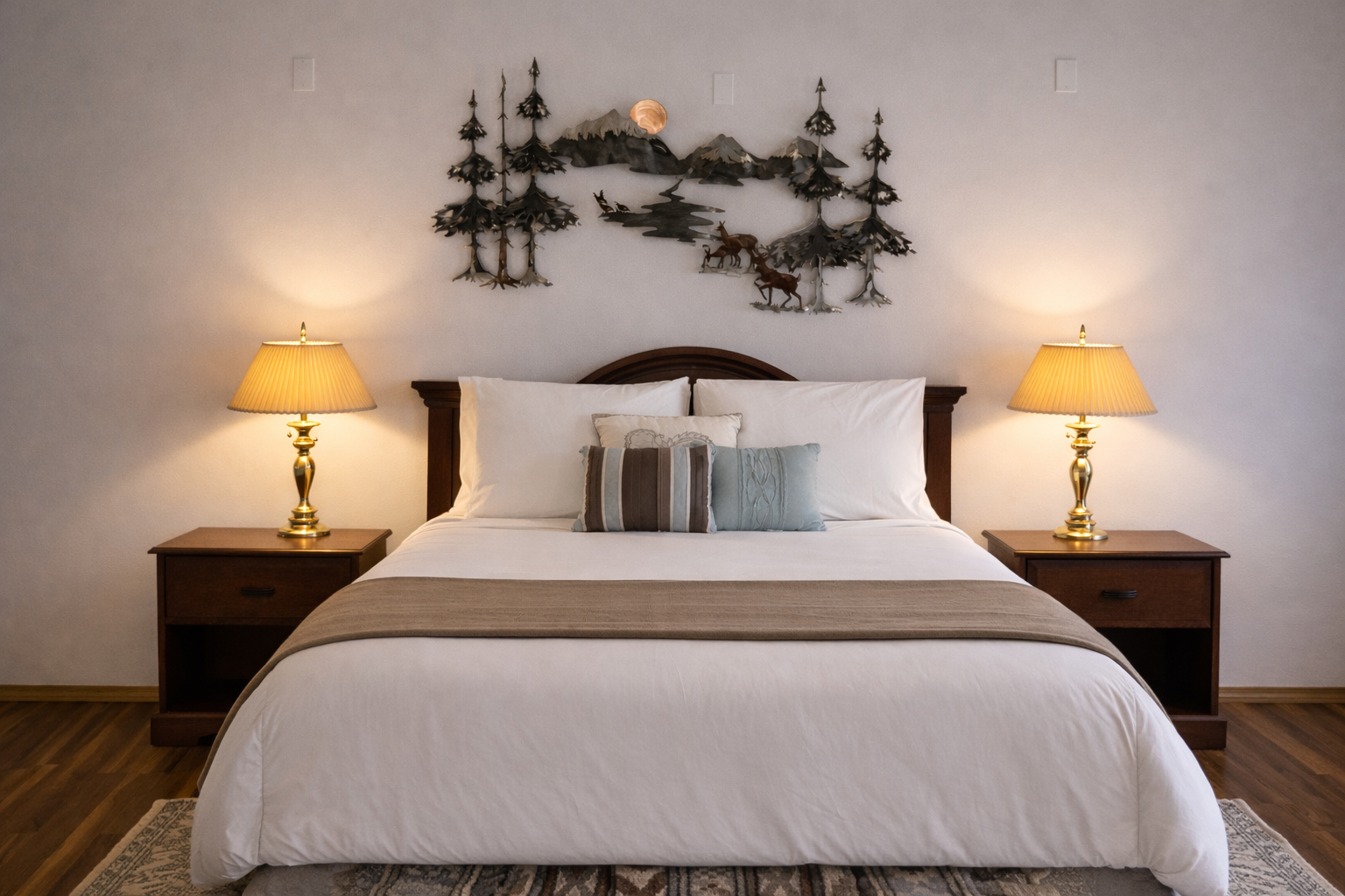 Sink into crisp white linens beneath charming wilderness art that creates your perfect mountain retreat atmosphere.