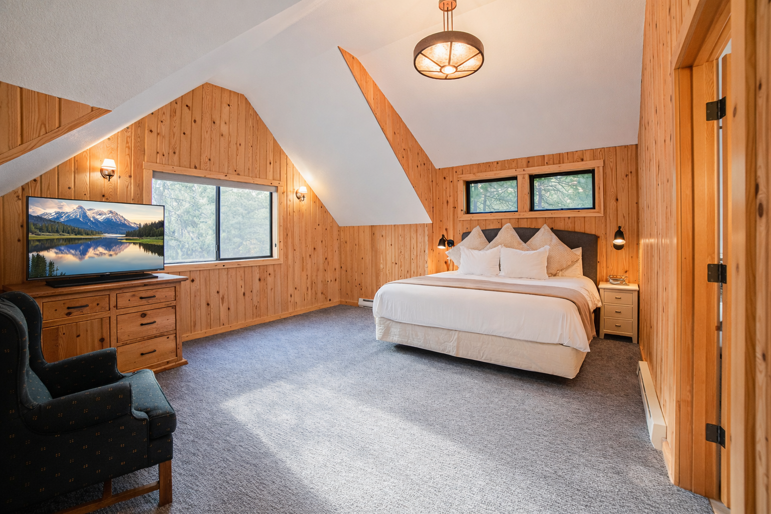 Relax in your cozy loft bedroom with warm wood accents, plush bedding, and peaceful mountain views from your windows.