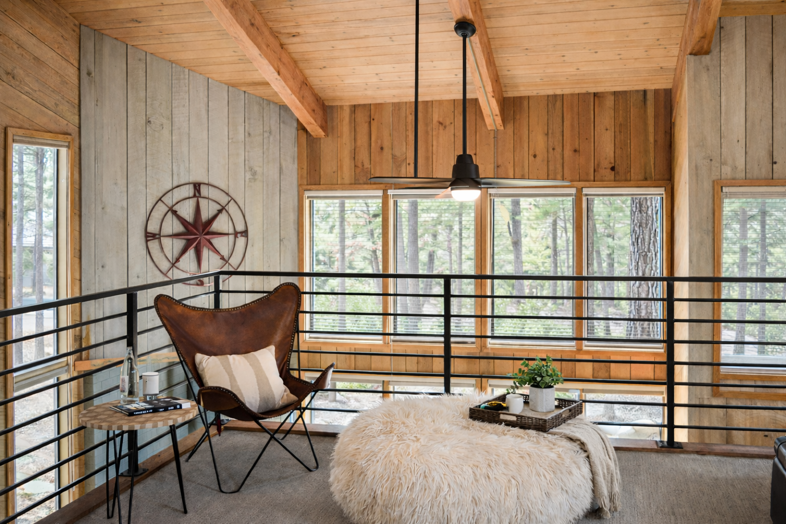Unwind in your private loft retreat with forest views, cozy leather seating, and rustic wood details that create the perfect woodland escape.