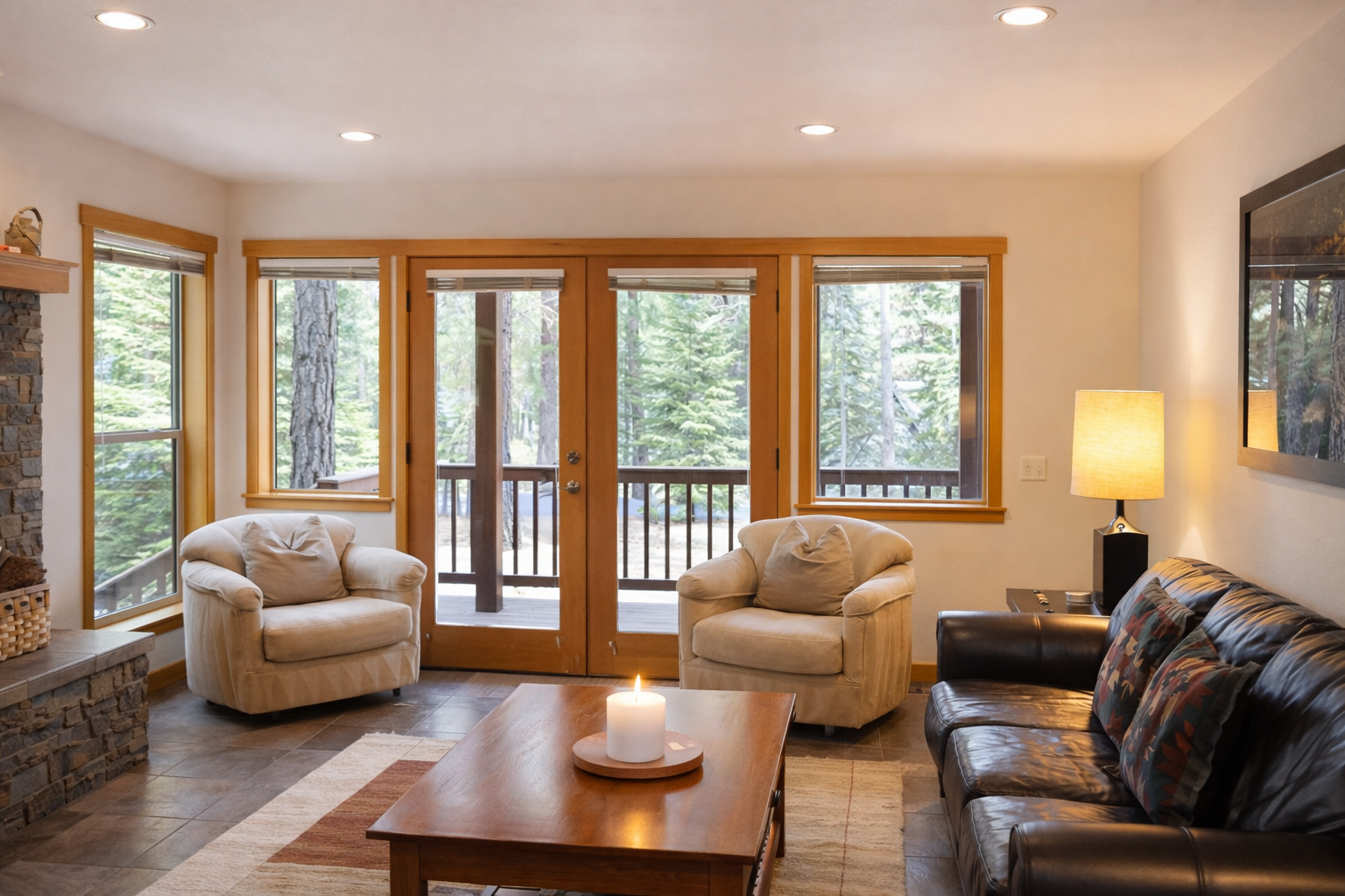 Unwind in your cozy living room with plush seating and stunning forest views through expansive windows.