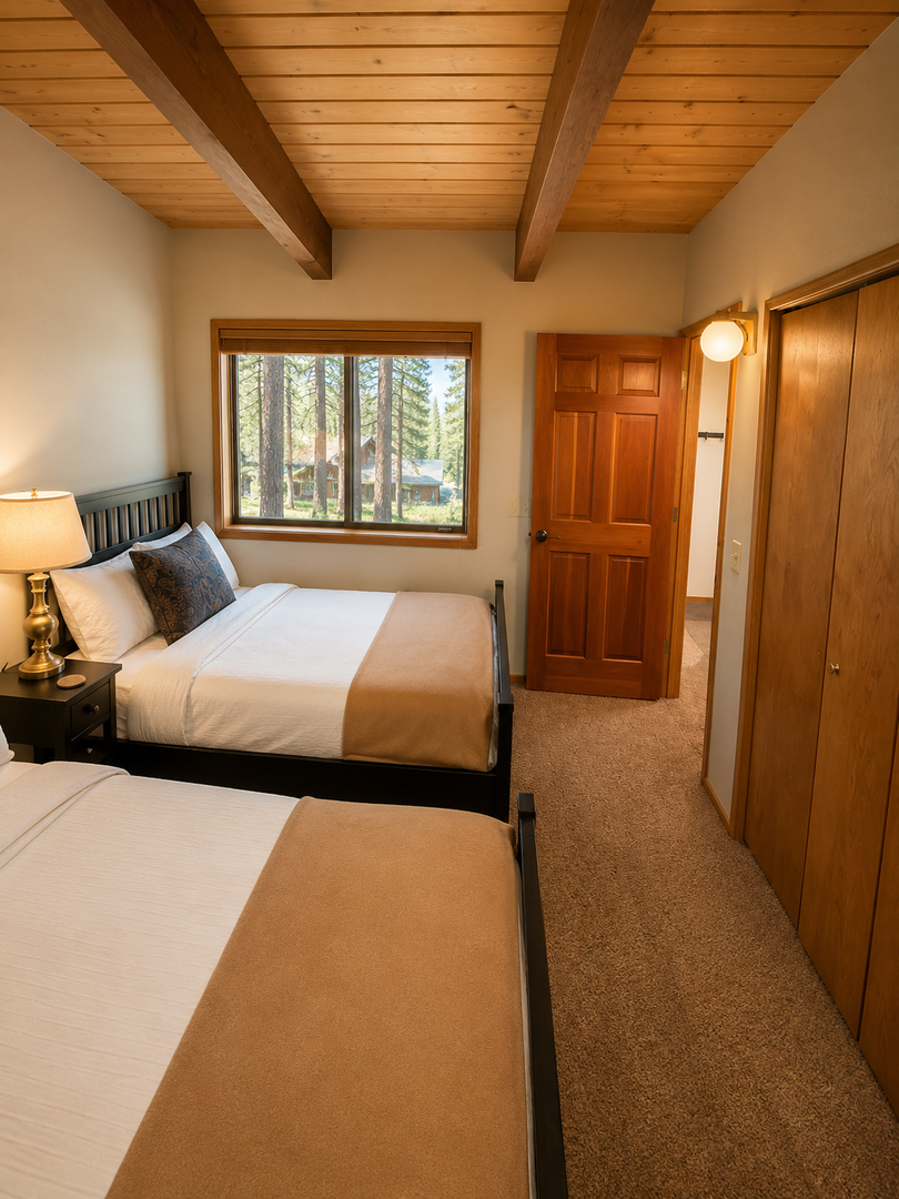 Unwind in your cozy bedroom with warm wood-beam ceilings, crisp linens, and a peaceful forest view just outside your window—your mountain retreat awaits.