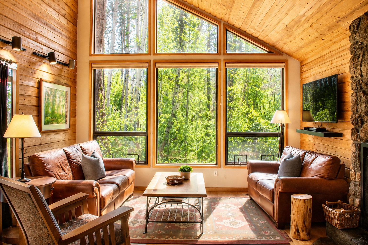 Sink into plush leather sofas and take in stunning forest views through soaring windows—your peaceful retreat surrounded by nature awaits.