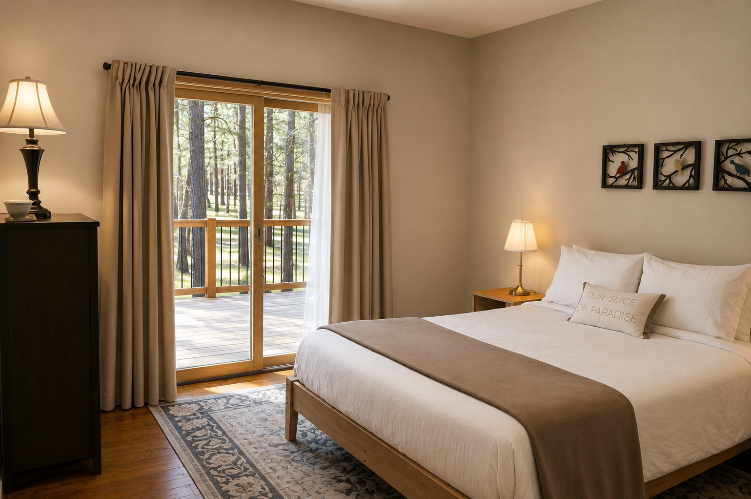 Step into your serene bedroom, where crisp white linens invite restful nights. Glass doors open to your private deck, framing peaceful forest views that welcome you to unwind.