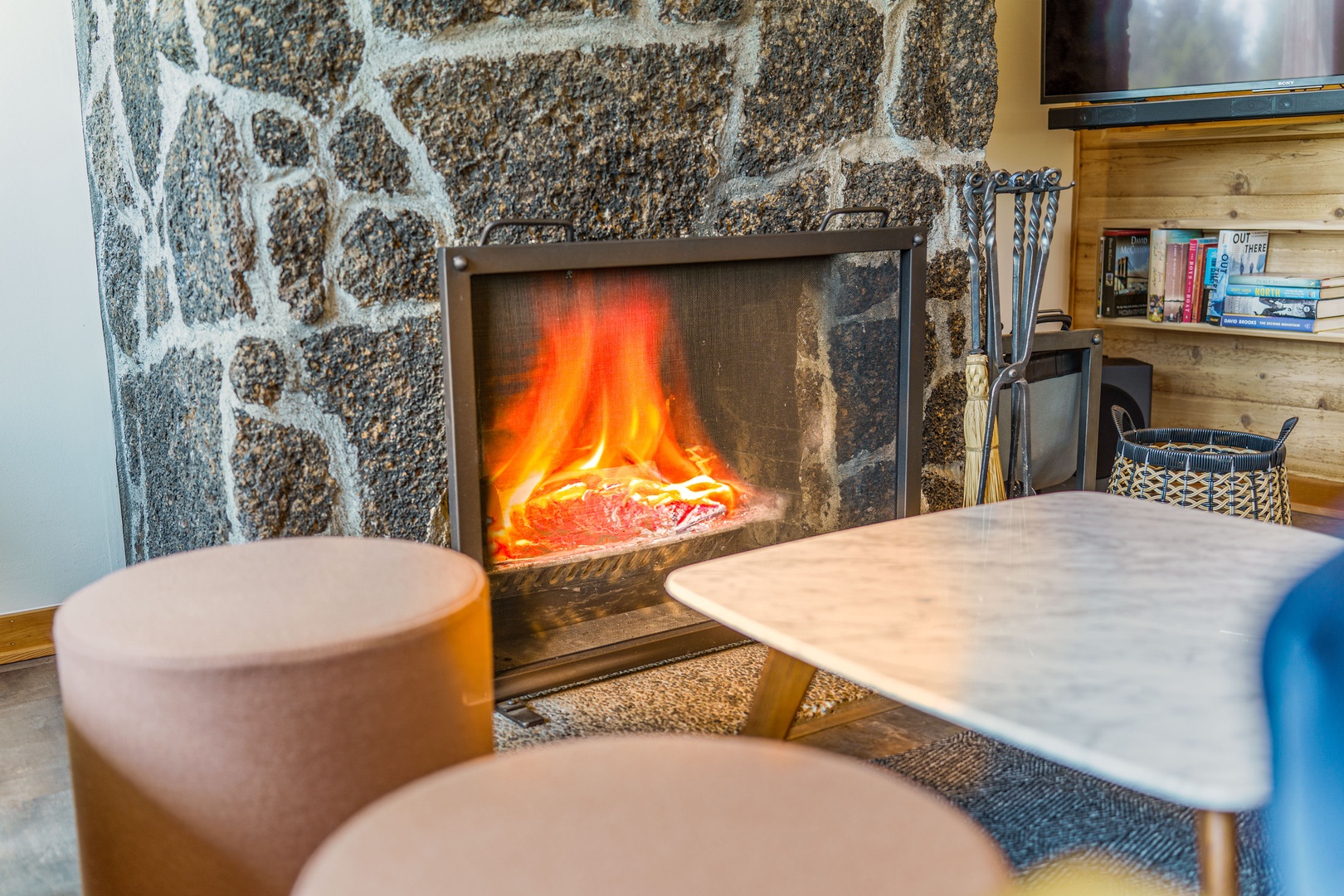 Cozy up by your crackling fireplace with a good book from the shelf, feeling the warmth dance across your skin.