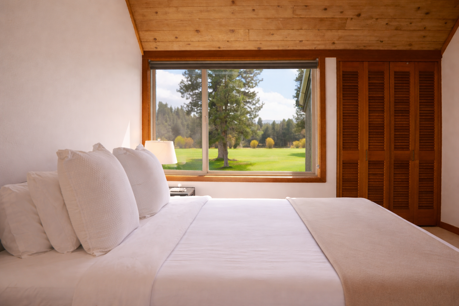 Wake up to crisp morning air and stunning golf course views from your cozy bed.