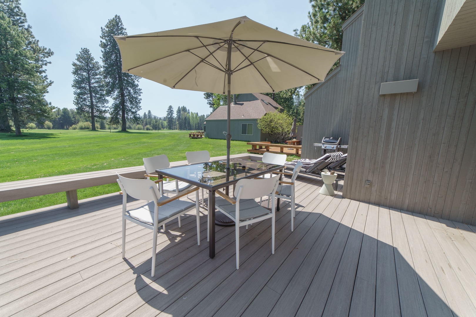 Your private deck overlooks lush fairways, perfect for morning coffee or sunset dinners under the umbrella's shade.