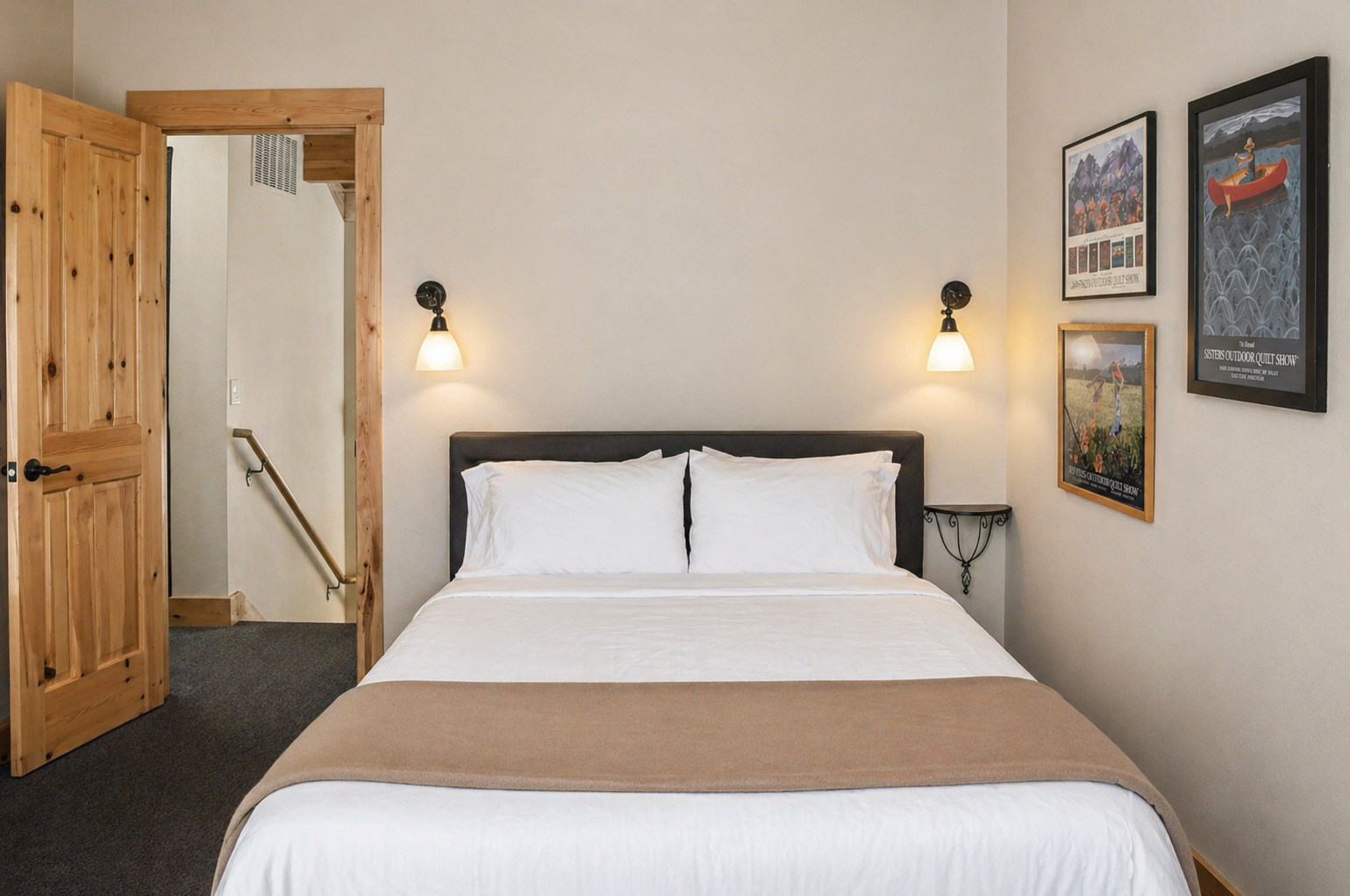 Your cozy bedroom features crisp white linens and warm sconces creating the perfect ambiance for restful nights.