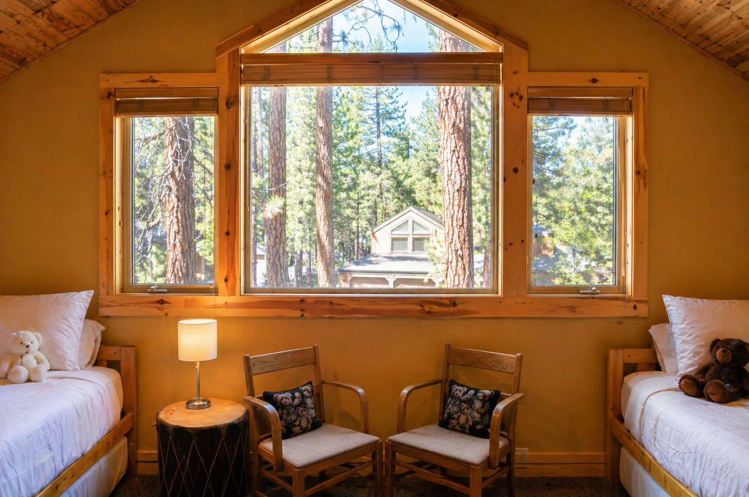 Wake up to towering trees outside your cozy cabin bedroom, where warm wood accents and twin beds create your perfect forest retreat.