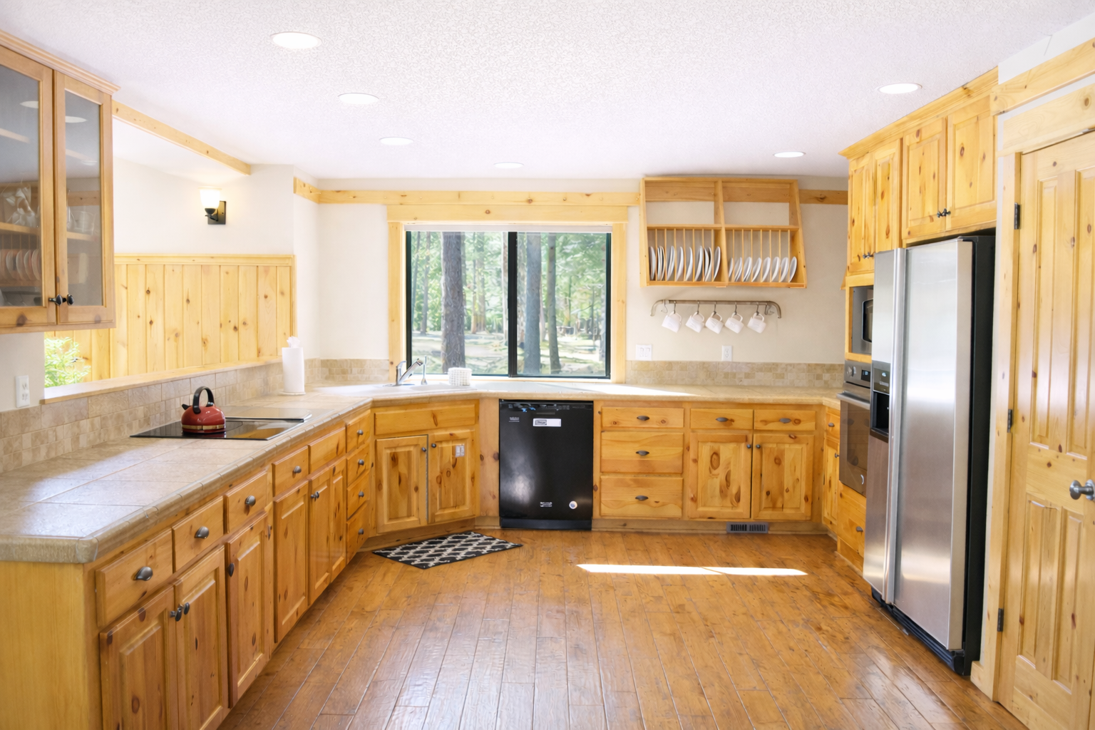 Your spacious kitchen features beautiful pine cabinets and forest views, perfect for preparing meals with friends and family.