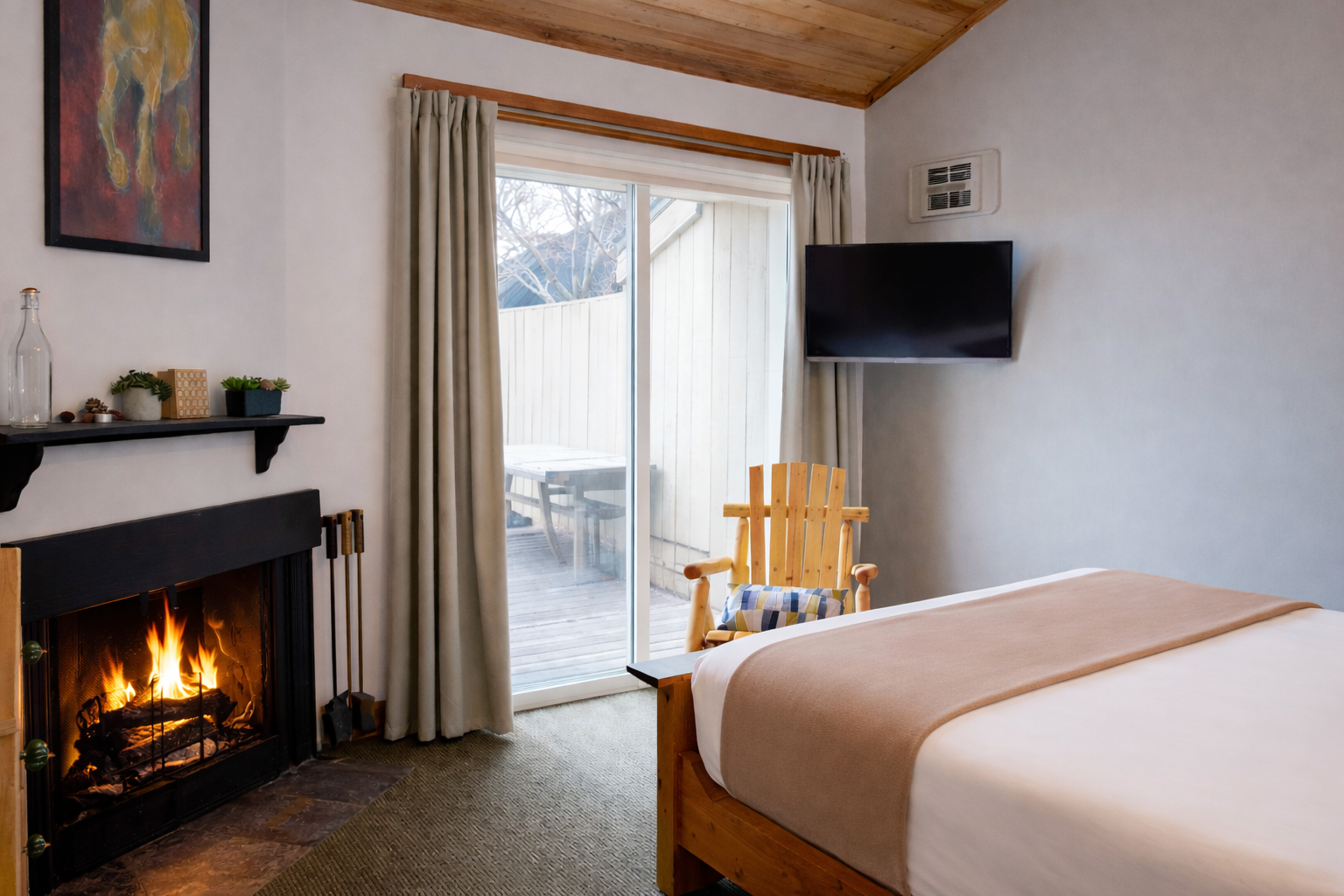 Unwind in your cozy retreat with a crackling fireplace, plush bedding, and rustic wood accents creating the perfect romantic escape.