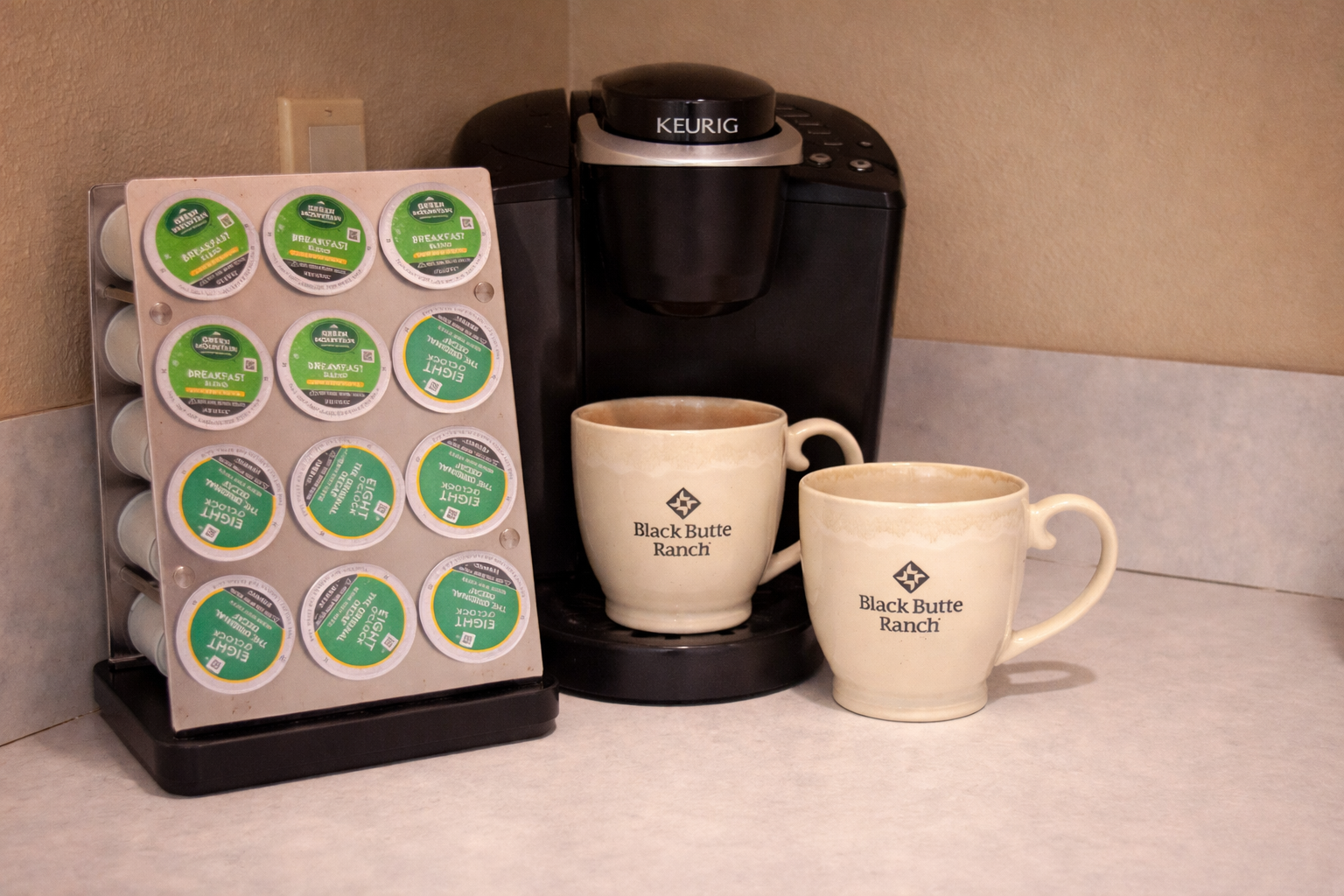 Start your mornings with fresh coffee from the Keurig maker, complete with K-cup selection and branded mugs for a perfect brew.