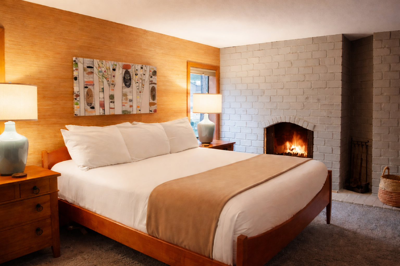 Unwind in your cozy bedroom where warm wood tones and a crackling fireplace create the perfect romantic retreat for peaceful nights.