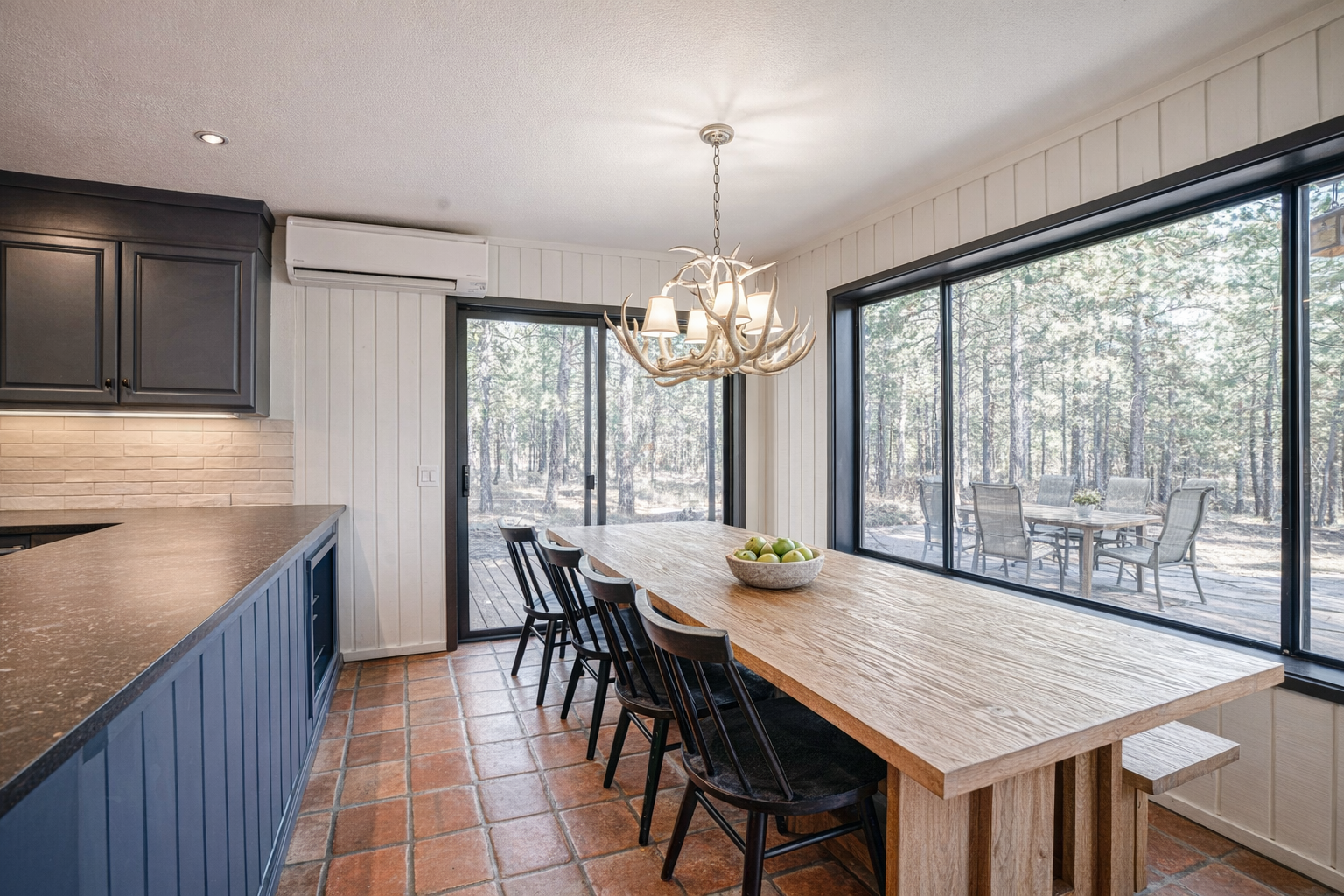 Gather around this handcrafted table where morning coffee meets rustic elegance, with forest views creating your perfect breakfast backdrop.