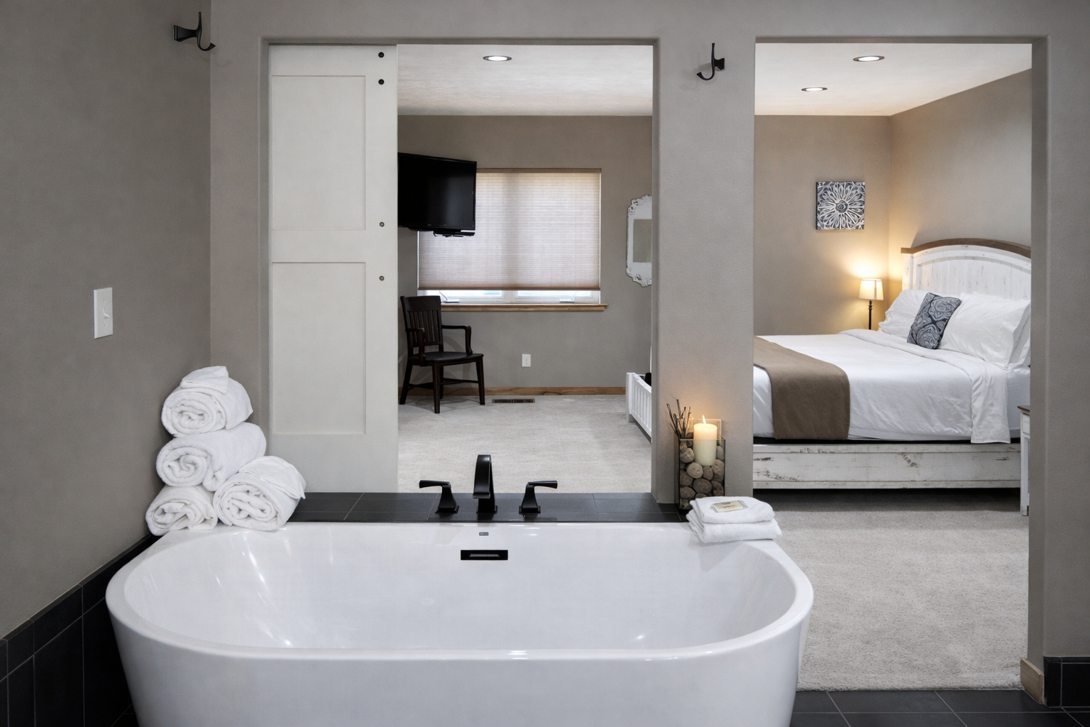Sink into your private soaking tub while watching TV or gazing into the cozy bedroom beyond.