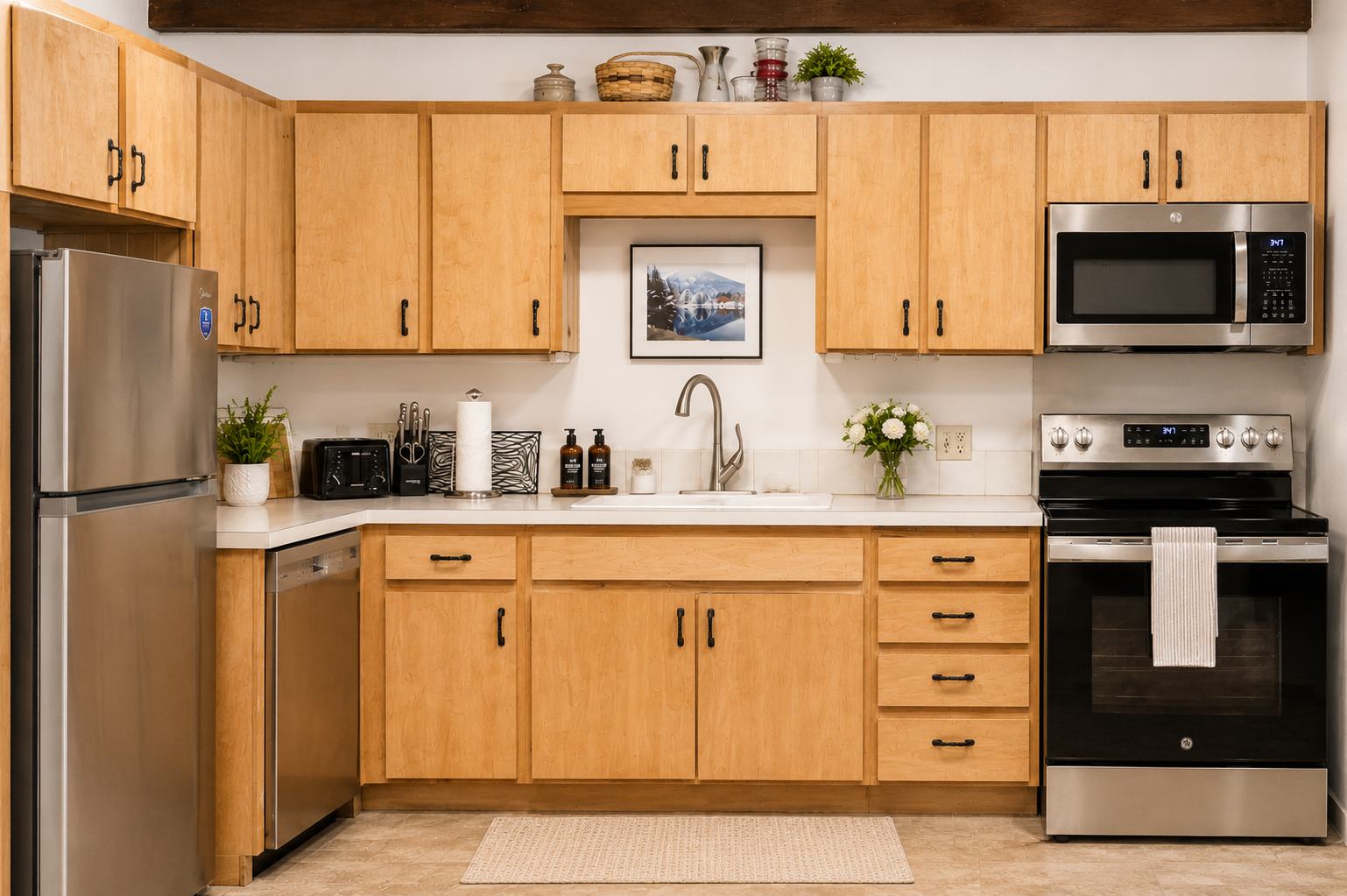 Your fully equipped kitchen awaits with stainless steel appliances, ample cabinet space, and thoughtful touches like fresh flowers—everything you need to cook and gather comfortably.