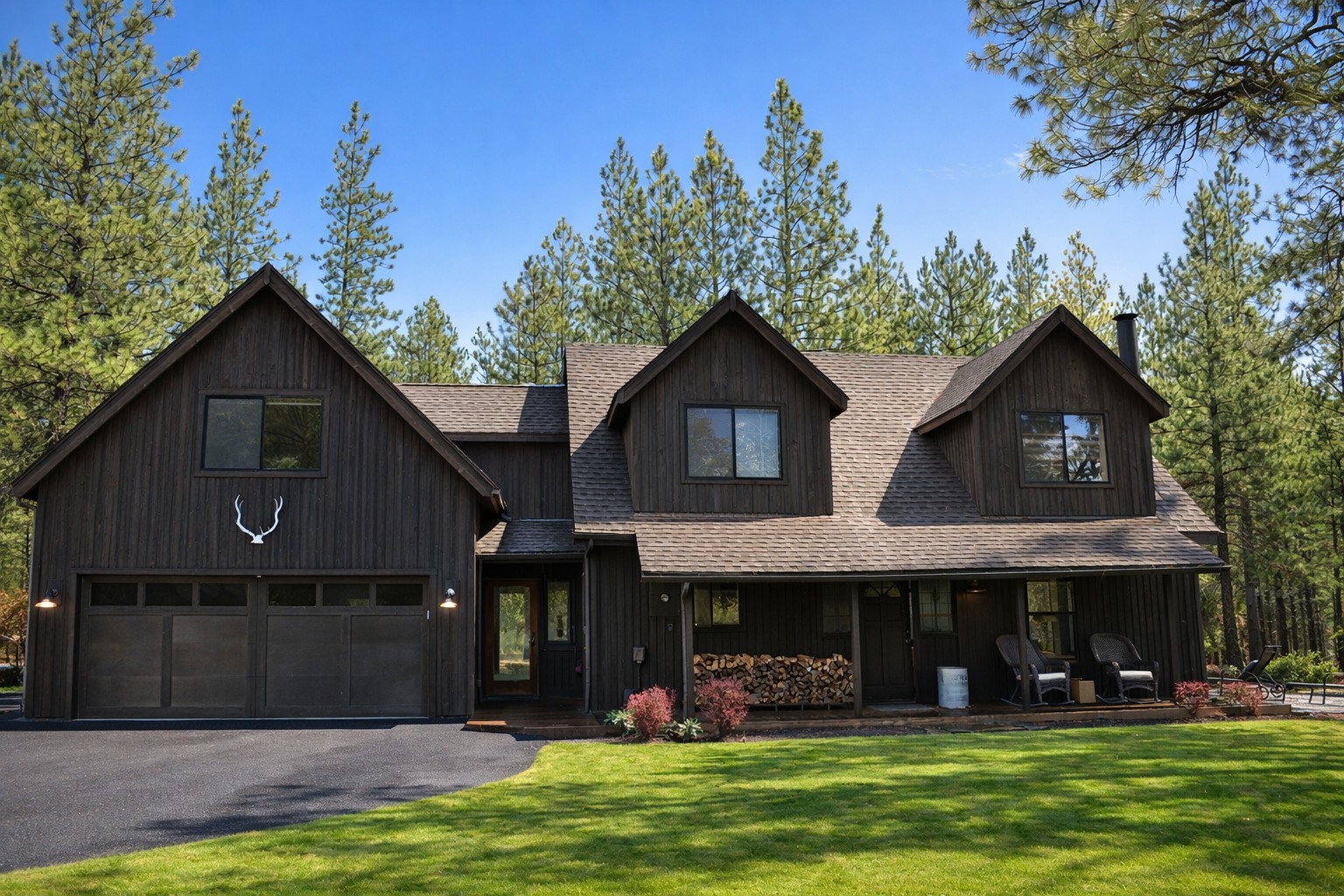 Rustic mountain lodge nestled among towering pines with spacious lawn and charming architectural details.