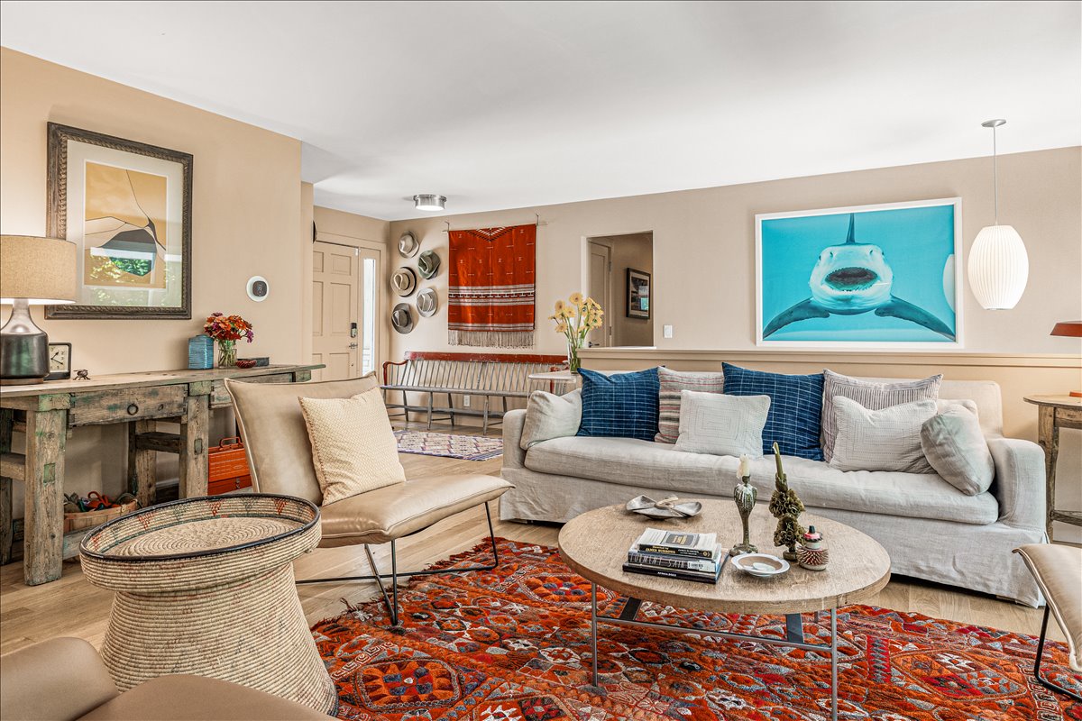 Sink into plush sofas surrounded by curated art and ocean-inspired decor, where your perfect retreat awaits with warmth and sophisticated comfort.