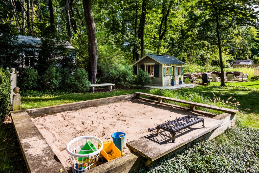 The large sandbox and playhouse are well stocked with the essential accessories