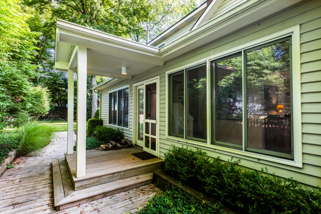 Main entrance with covered porch, along the side of the house