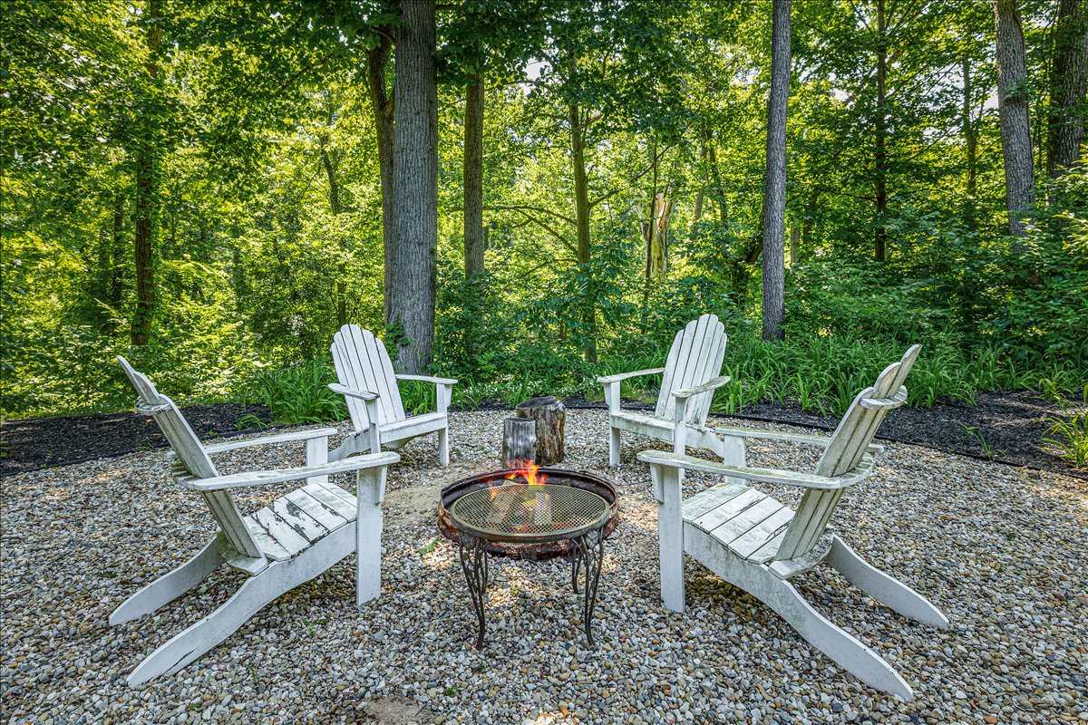 Gather around your private fire pit surrounded by comfortable Adirondack chairs in this peaceful forest setting—perfect for evening conversations and s'mores.