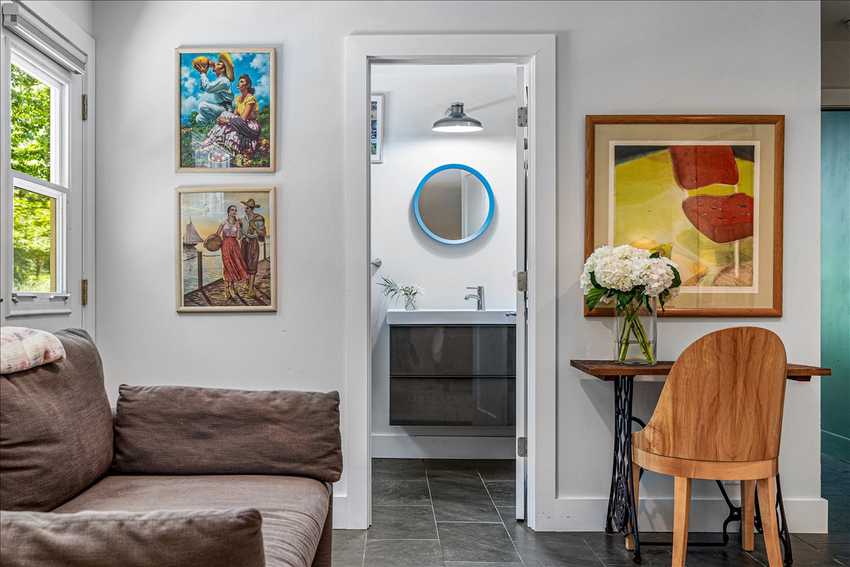 Sink into the plush sofa surrounded by curated artwork, while your private bathroom awaits just steps away with modern fixtures and stylish finishes.