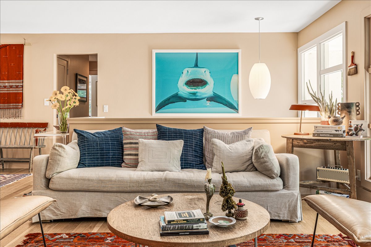 Sink into this stylish sofa surrounded by curated art and coastal vibes, where your morning coffee feels like a gallery moment.