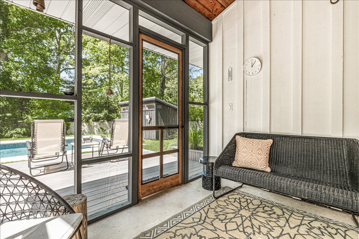 Relax in your cozy sunroom with pool views through floor-to-ceiling windows. Comfortable seating and direct patio access create the perfect indoor-outdoor flow.