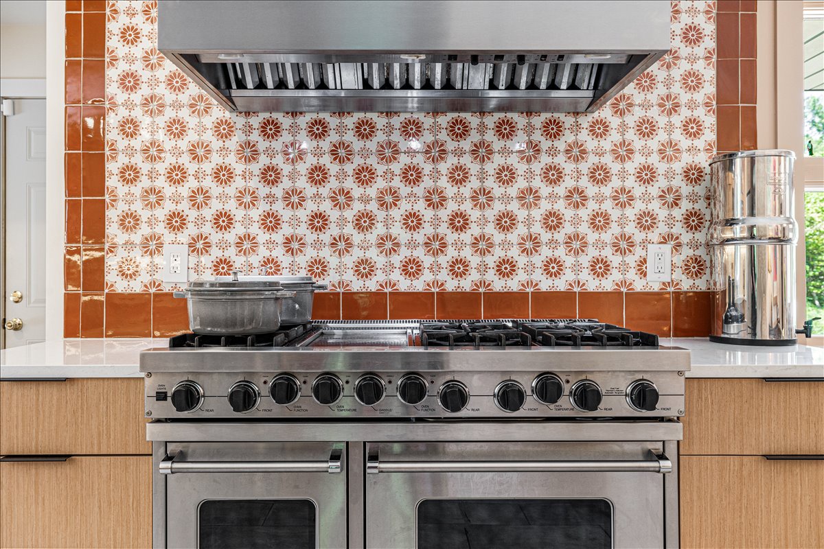 Your gourmet kitchen features a professional-grade range and stunning decorative tile backsplash, perfect for creating memorable meals during your stay.