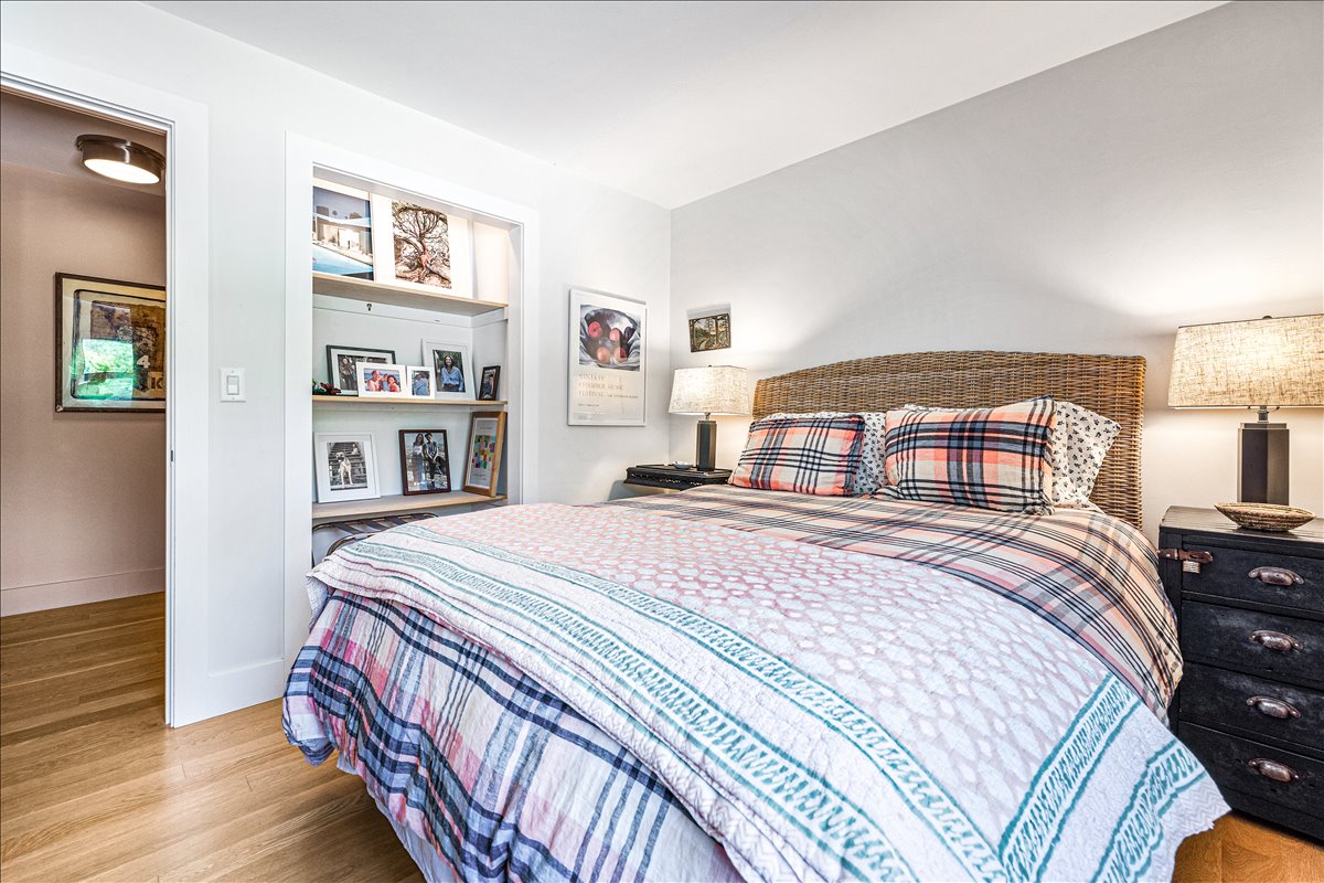 Drift off in your cozy bedroom with thoughtful touches like built-in shelving and warm lighting creating the perfect retreat.