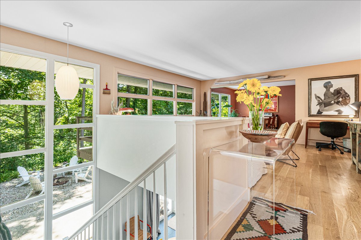 Your bright upper level workspace flows seamlessly through large windows overlooking lush treetops, creating the perfect spot for productivity.