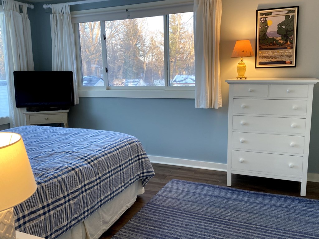 Queen bedroom with queen bed and pool view.