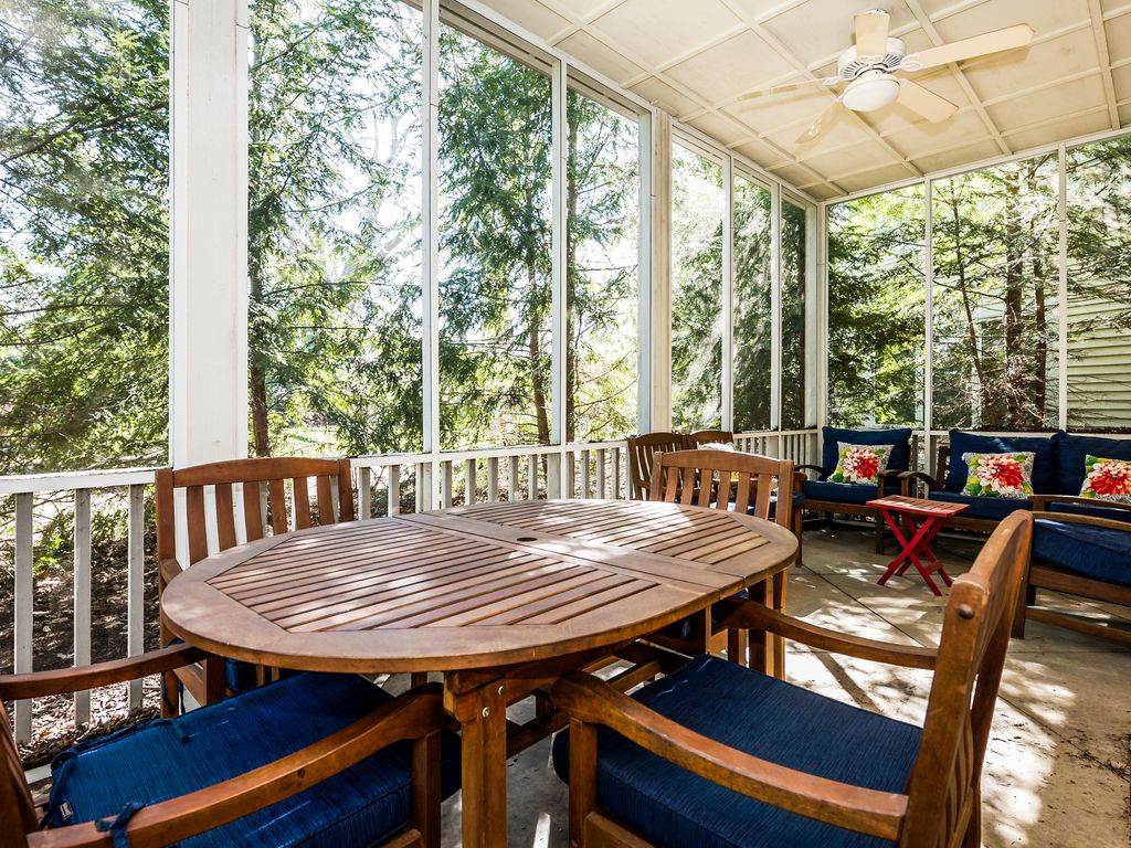 Screened-in porch has plenty of seating!