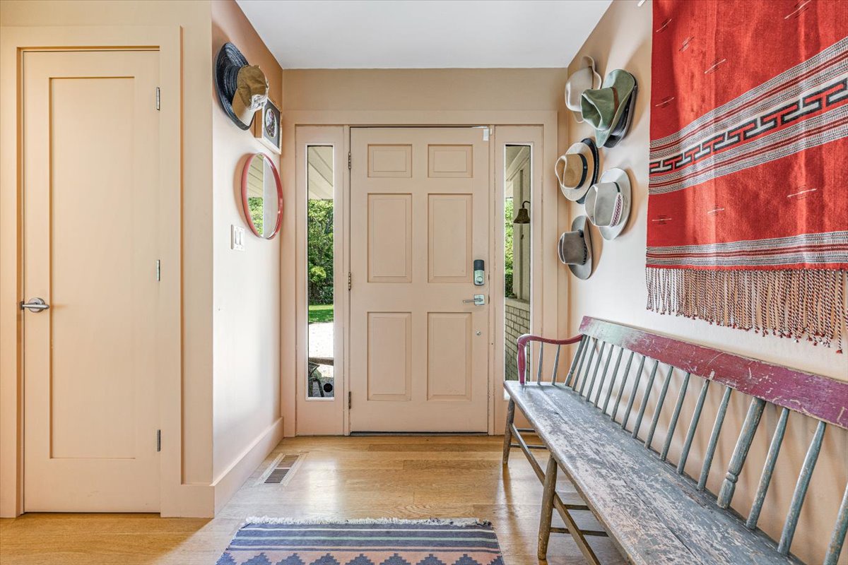 You'll love this charming entryway with its rustic bench and hat collection, where you can settle in and feel instantly at home.
