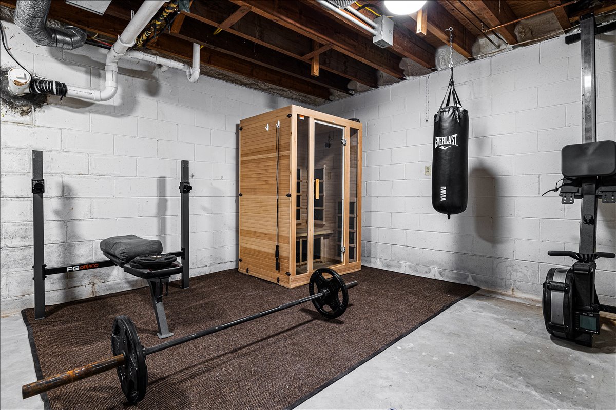 Your private basement gym features weights, punching bag, and sauna for complete workouts and relaxation.