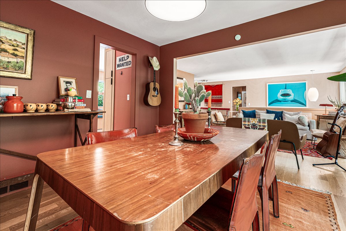 Gather around this warm, mid-century dining table where your meals become memorable moments in this thoughtfully curated space.