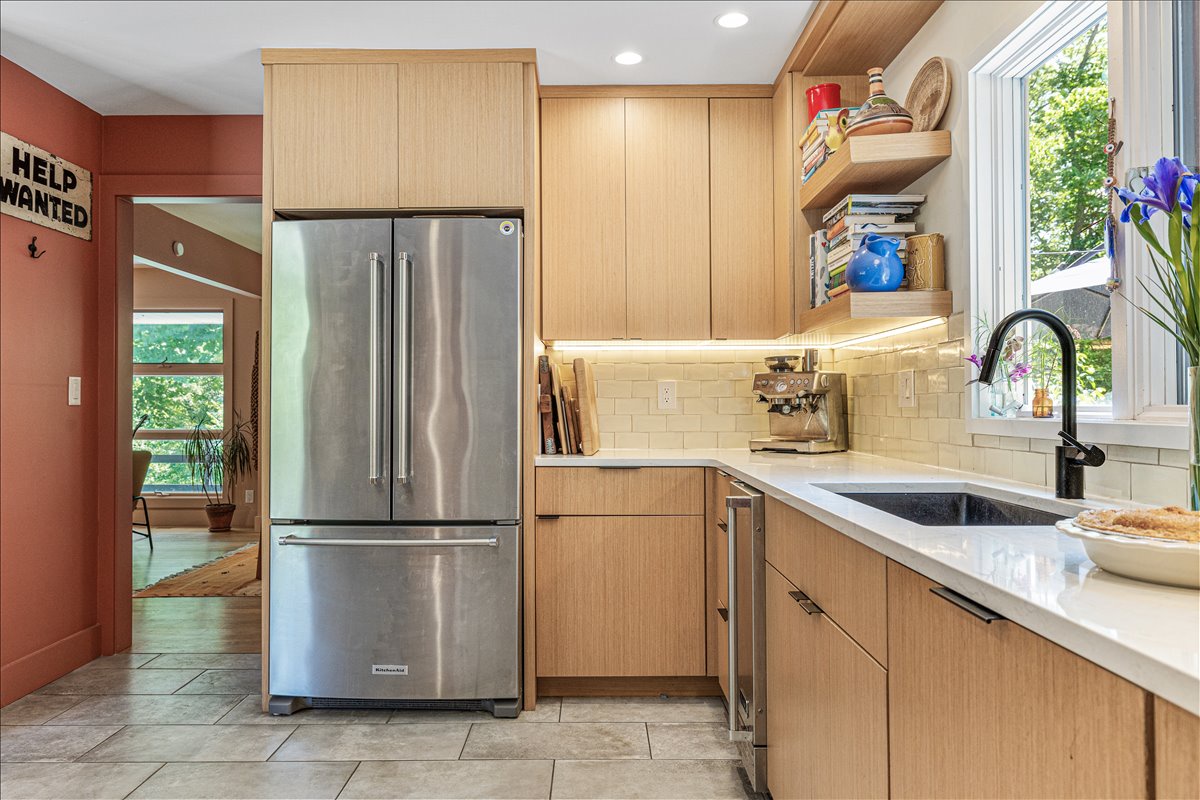 Your gourmet kitchen features sleek wood cabinetry, stainless steel appliances, and bright natural light - perfect for preparing memorable meals.