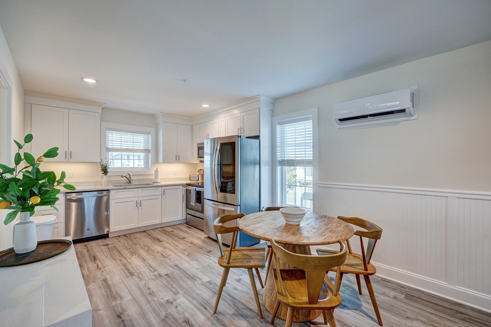 Your bright kitchen welcomes you with sleek white cabinets, stainless steel appliances, and warm wood floors, creating the perfect space for memorable meals.