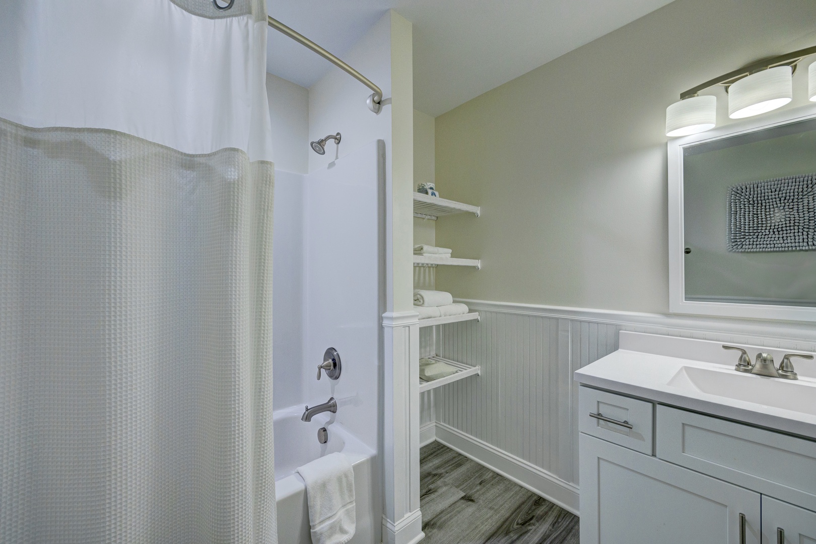 Refresh in your private bathroom with a tub-shower combo, built-in storage shelving, and modern vanity - thoughtfully designed for your comfort.