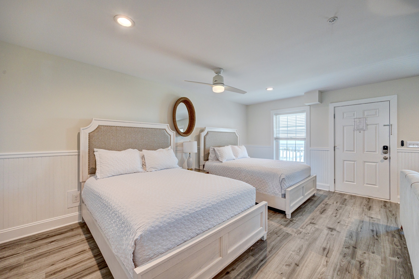 Rest peacefully in your serene bedroom with two comfortable queen beds and coastal charm.
