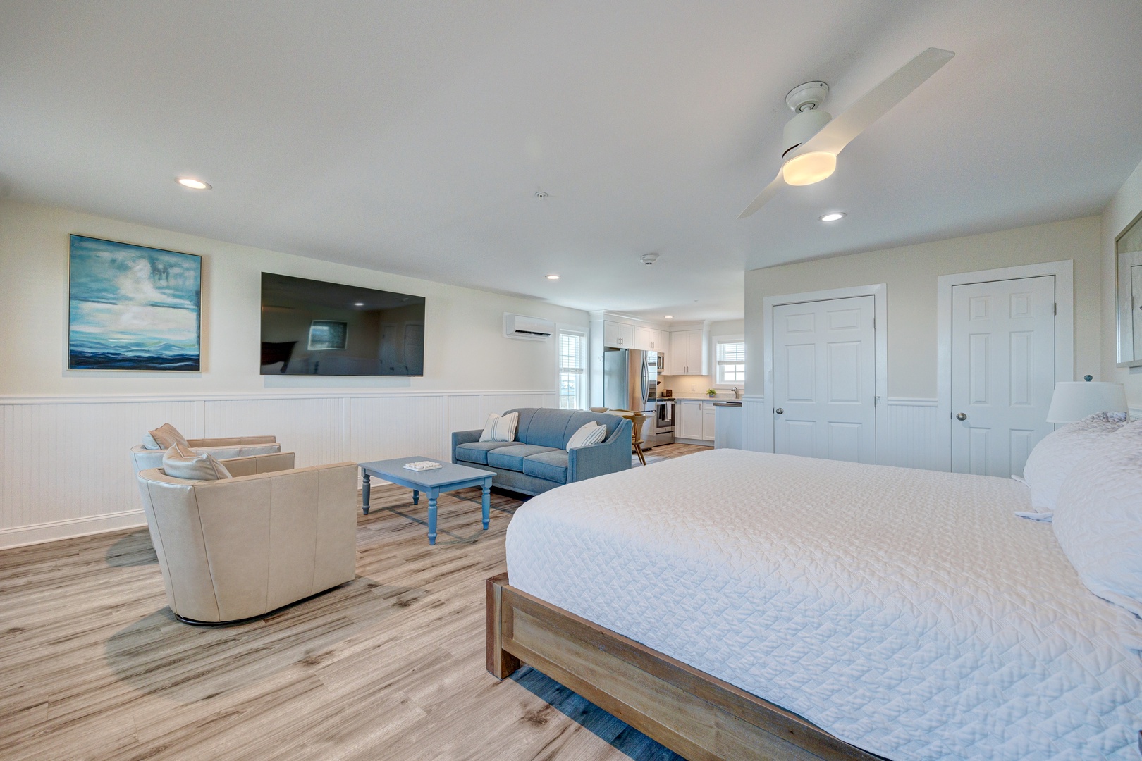 Your spacious bedroom suite combines sleeping and lounging areas perfectly, with comfortable seating and a wall-mounted TV for ultimate relaxation.
