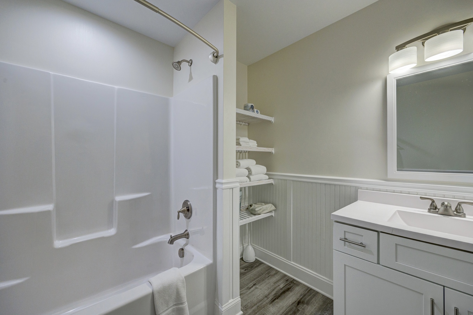Your private bathroom features fresh linens, built-in shelving, and everything needed for a relaxing soak after your adventures.
