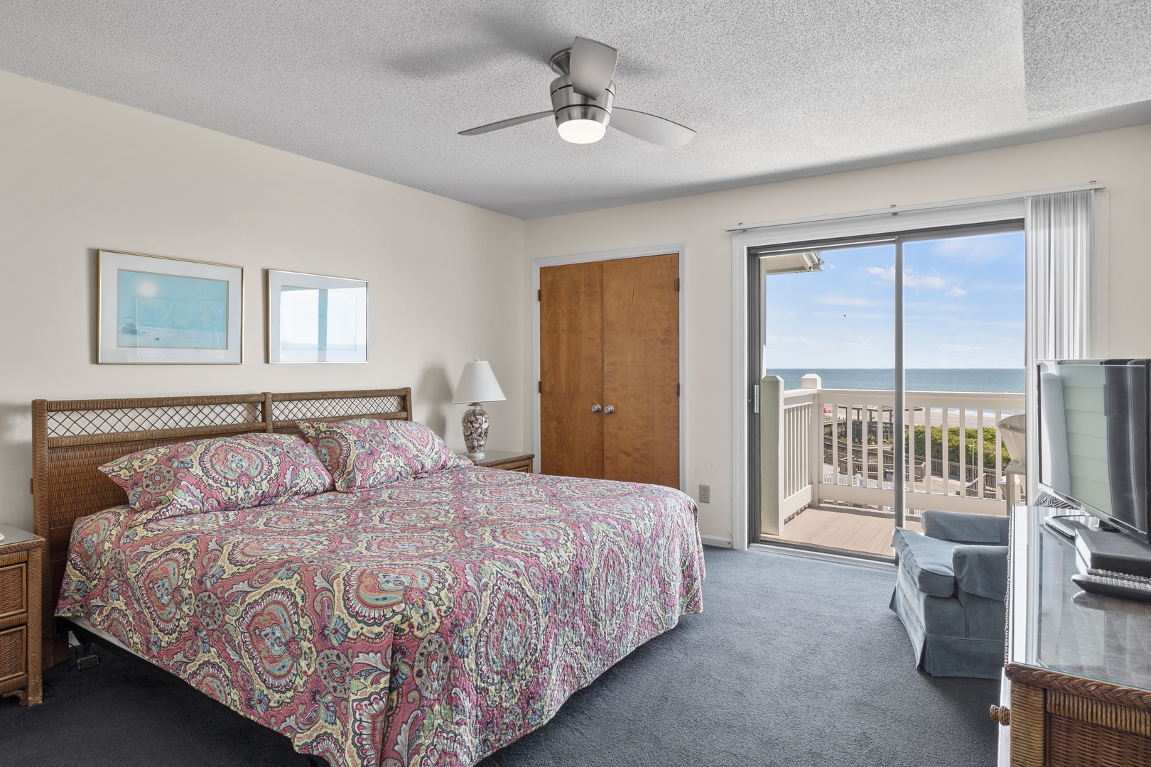 Primary bedroom with king bed & ocean view