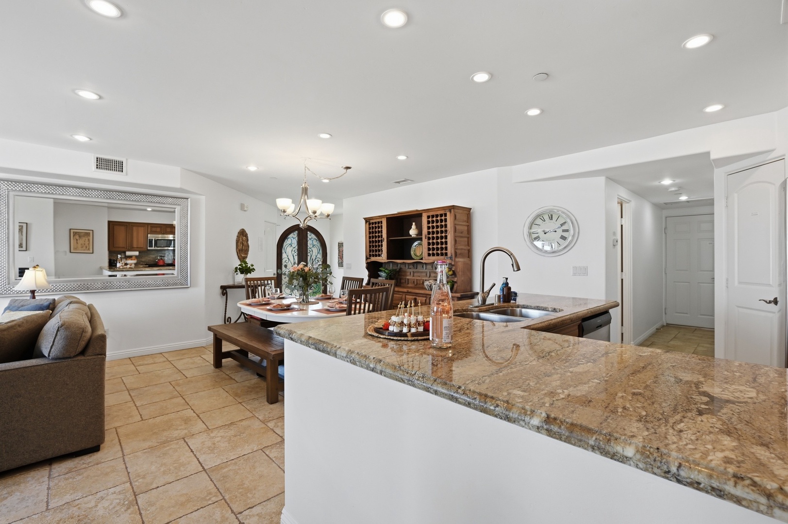 Your open kitchen flows seamlessly into the living space, featuring granite counters and warm wood accents perfect for entertaining.