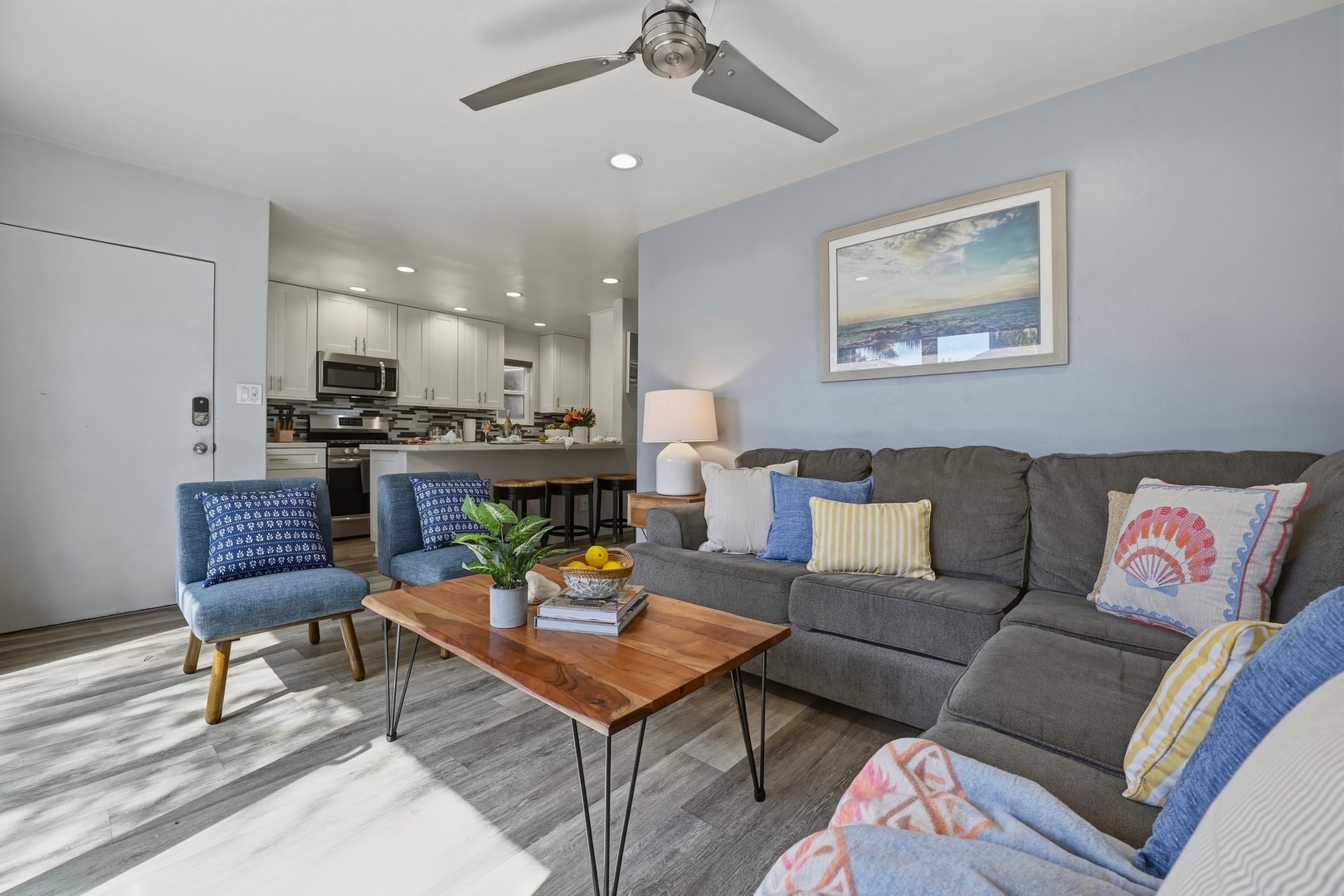 Open living area with ceiling fan