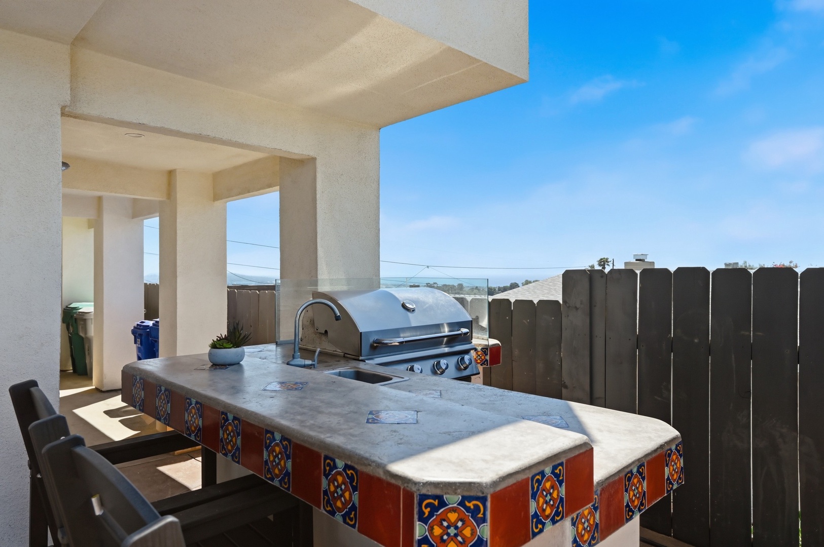 Fire up your vacation at this colorful outdoor kitchen with built-in grill and ocean views.